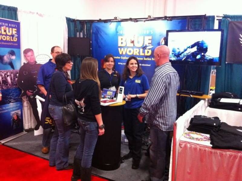 Our booth with lots of people hanging out, watching Blue World on the 42in. HD monitor and asking questions. &copy; Jonathan Bird’s Blue World TV
